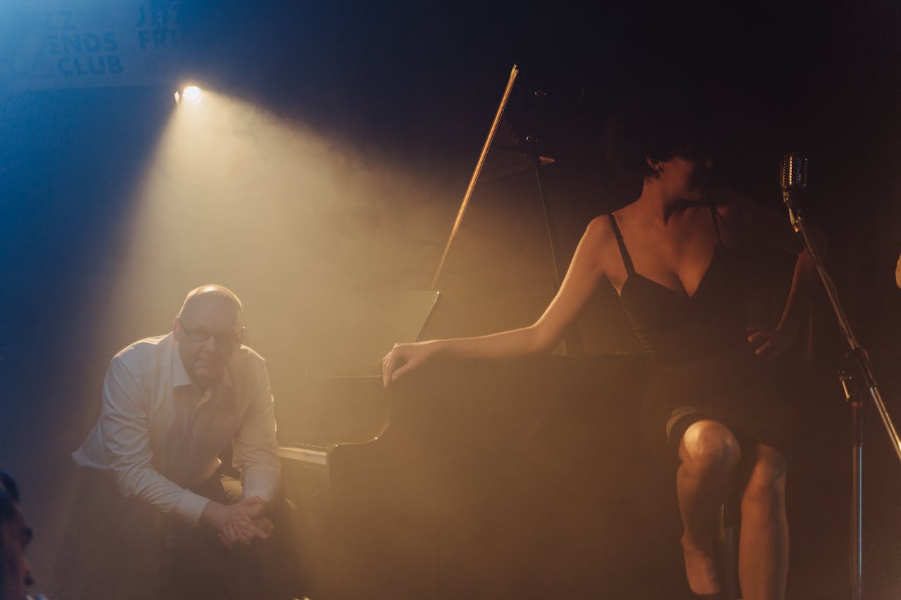 Moody jazz club performance featuring a pianist and singer on stage.